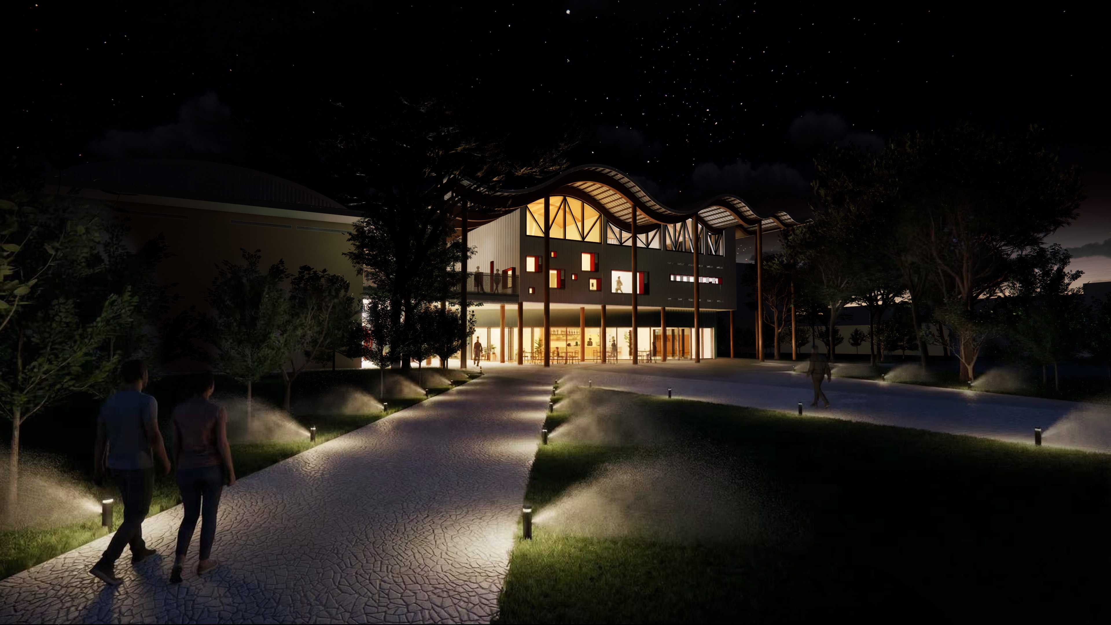 On hot-wave nights, soft lighting, misted lawns, and the warm timber glow of the wavy roof create a calm, breezy walkway where people stroll in cool, gentle comfort.