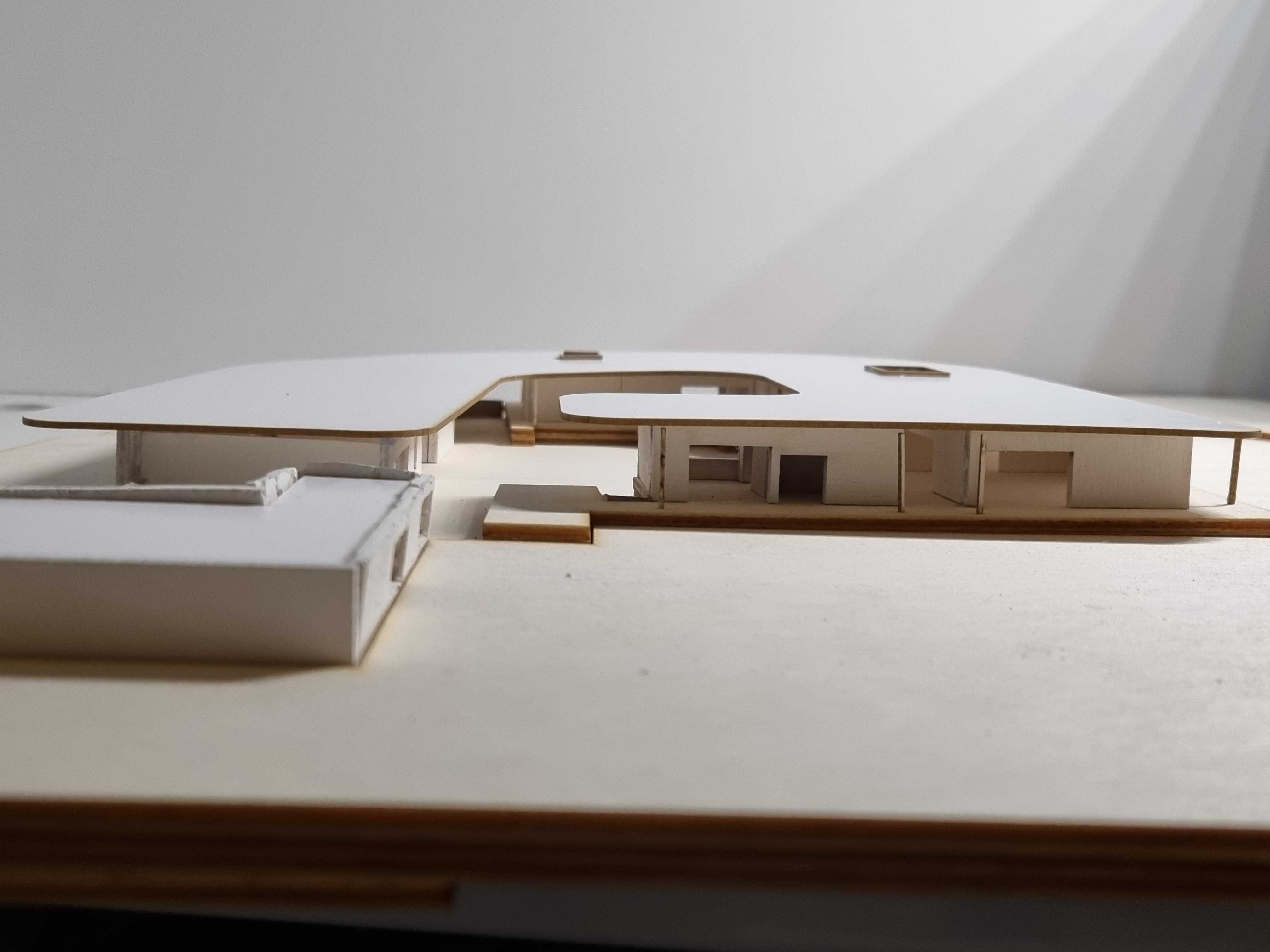 The physical model demonstrates the project’s spatial massing, revealing its layered forms, recessed volumes, and gentle integration into the contoured landscape.
